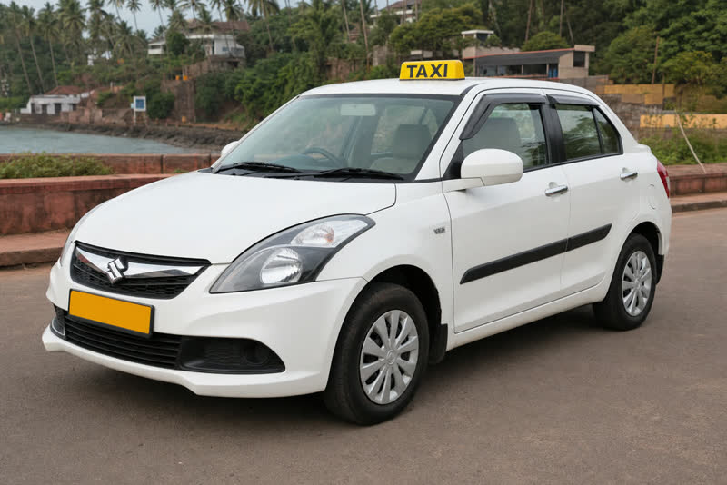 White sedan Goa taxi with yellow TAXI roof board